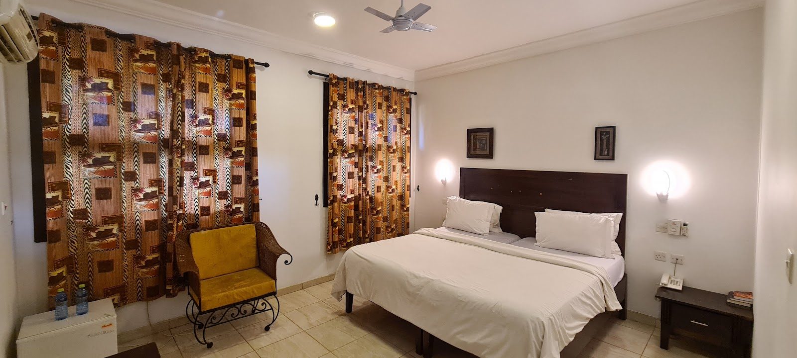 Bright en-suite guest room with double bed, seating and air conditioning