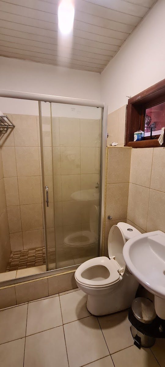 Private tiled bathroom with shower enclosure