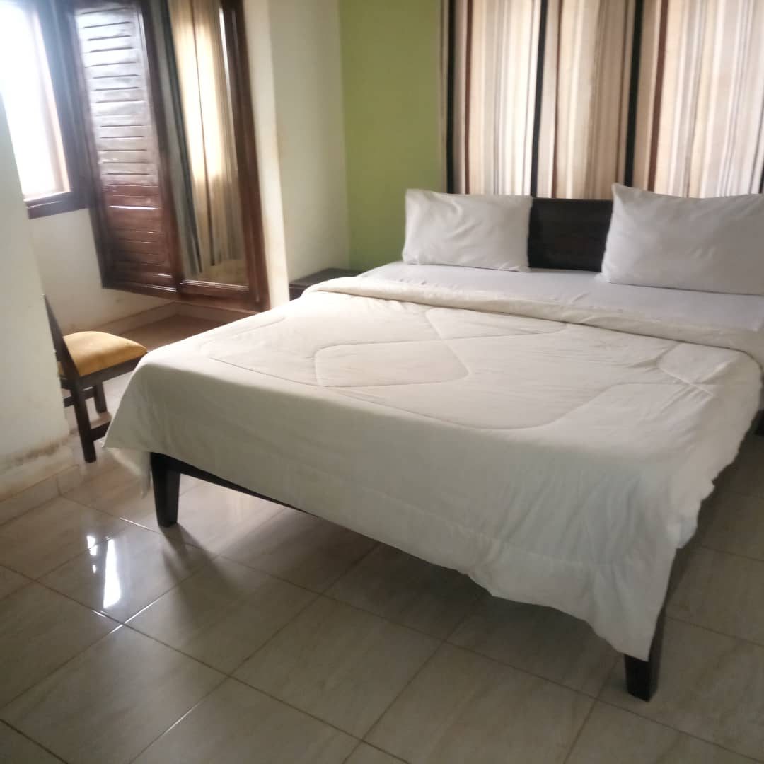 Guest room with a neatly made double bed